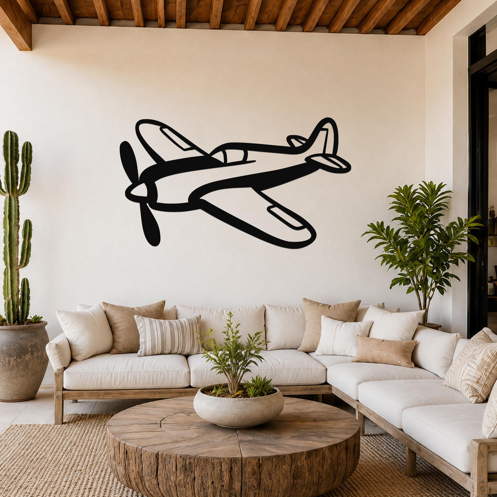 Black metal airplane wall art with a bold silhouette design, mounted on a living room wall above a white sofa.
