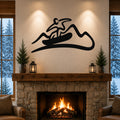 Black metal wall art with a snowboarder silhouette above a stone fireplace in a cozy living room.