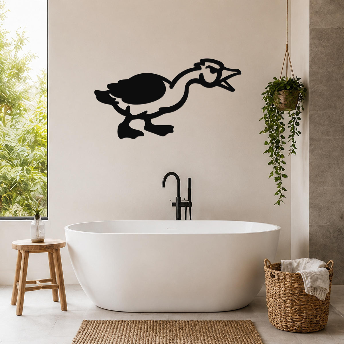 Black metal goose wall art with a minimalist silhouette design, mounted on a bathroom wall above a freestanding tub.