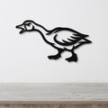 Black metal goose wall art with a silhouette cutout design, mounted on a white wall above a light wood countertop.