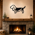 Black metal Basset Hound silhouette wall art mounted above a stone fireplace in a rustic living room.