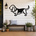 Black metal Basset Hound silhouette wall art mounted on a white shiplap wall above a wooden bench on a porch.