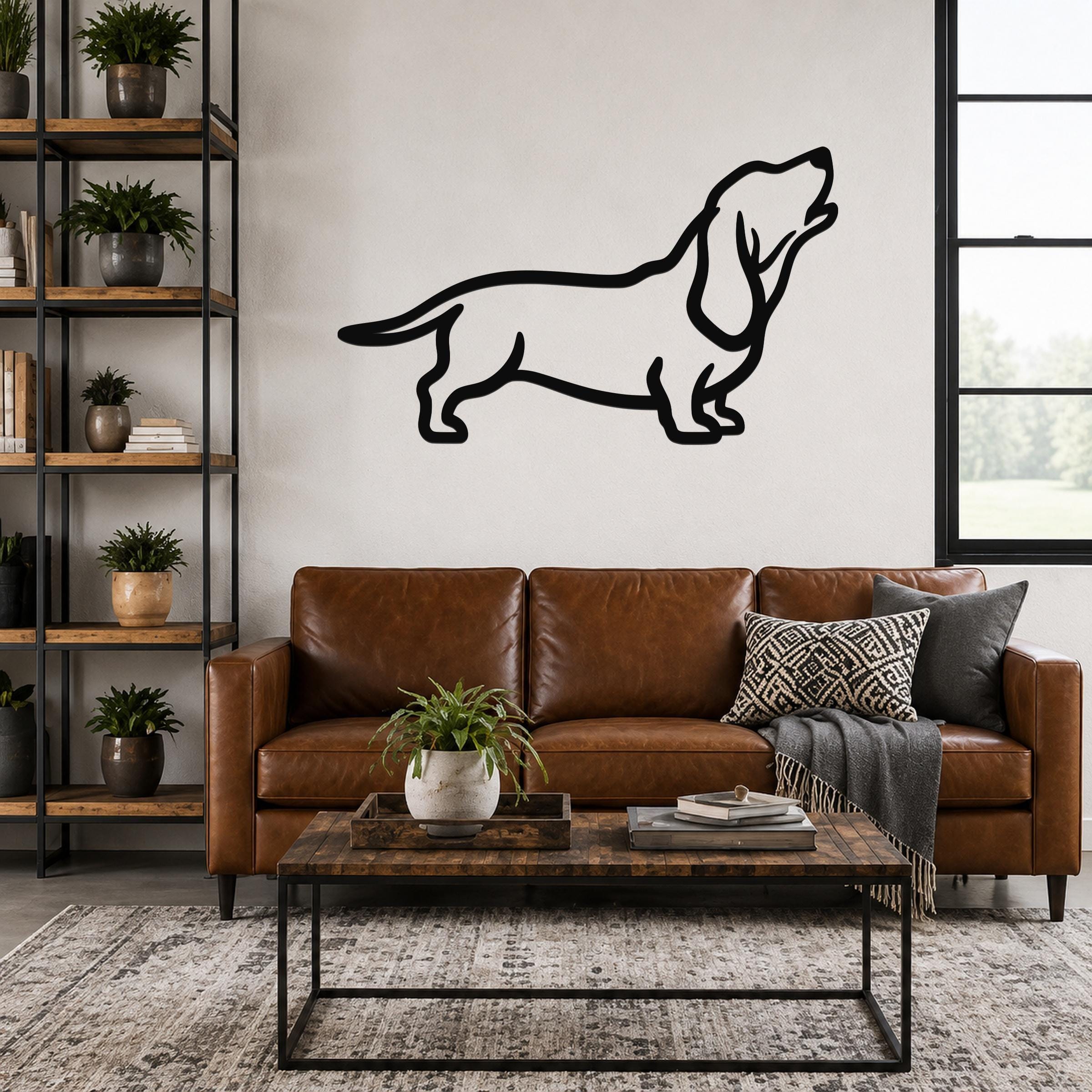 Black metal Basset Hound silhouette wall art mounted above a brown leather sofa in a living room.