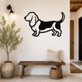 Black metal Basset Hound wall art silhouette mounted on a white wall above a wooden bench in a hallway.