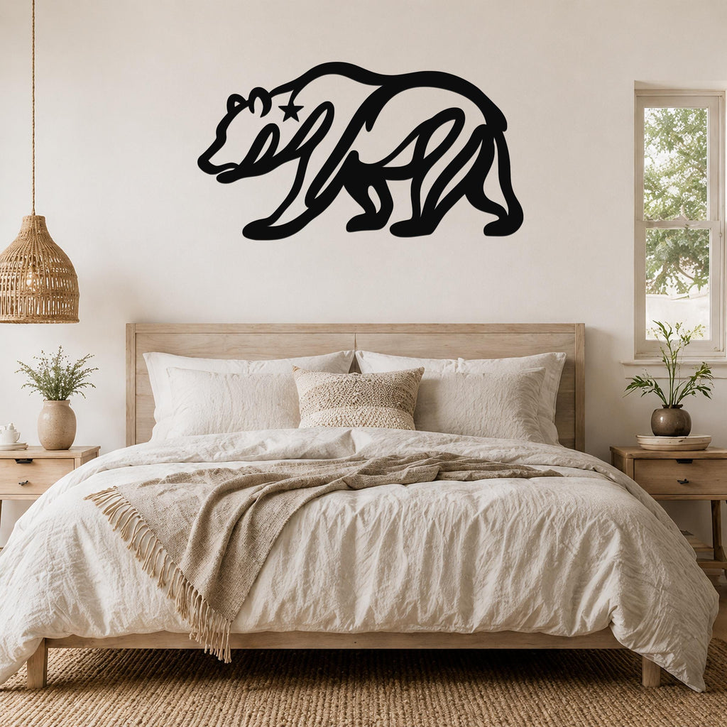 Black metal bear wall art with a star cutout, mounted above a wooden bed in a neutral bedroom.