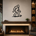 Black metal Bigfoot silhouette wall art mounted above a fireplace in a rustic living room.