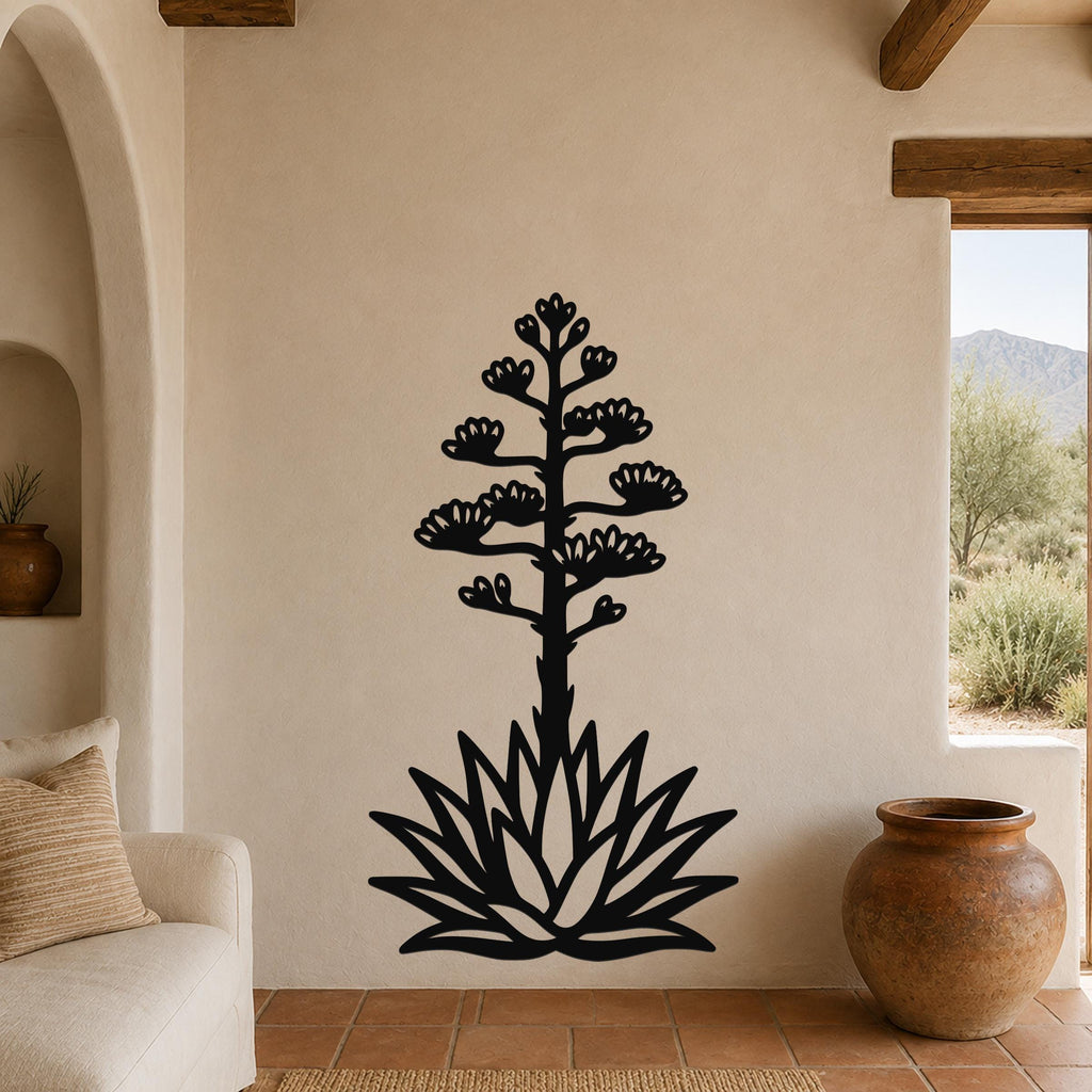 Black metal agave wall sculpture with blooming flower cutouts, mounted on a beige living room wall above a sofa.