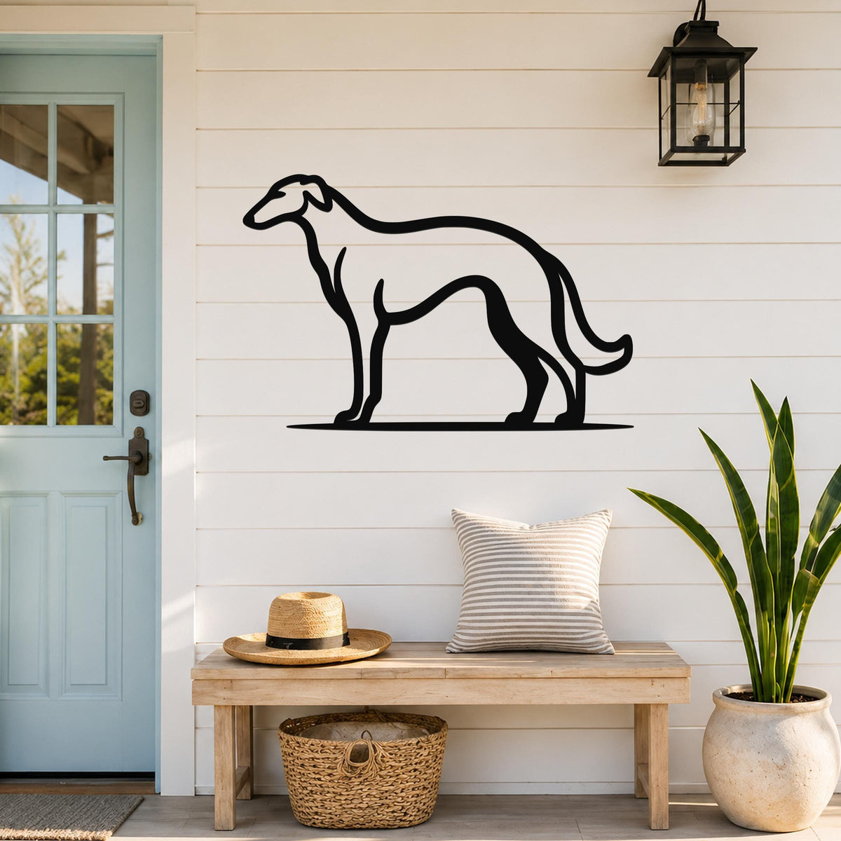 Black metal Borzoi dog wall art silhouette mounted on a white shiplap wall above a wooden bench in a porch entryway.