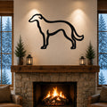 Black metal Borzoi dog silhouette wall art mounted above a stone fireplace in a cozy living room with snow outside the windows.