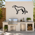 Black metal Borzoi dog silhouette wall art mounted on an outdoor kitchen wall above a stainless steel grill and counter.