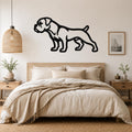 Black metal Boxer dog wall art silhouette mounted above a bed in a neutral bedroom.