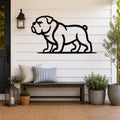 Black metal bulldog wall art silhouette mounted on a white shiplap wall above a wooden bench on a porch.