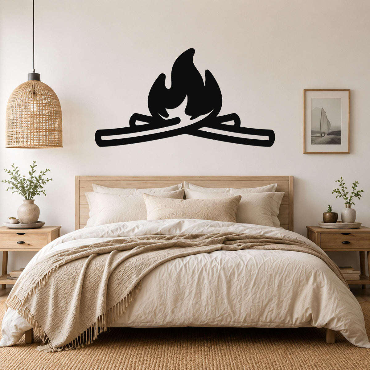 Black metal campfire wall art with flame and log silhouette, mounted above a wooden bed in a neutral bedroom.