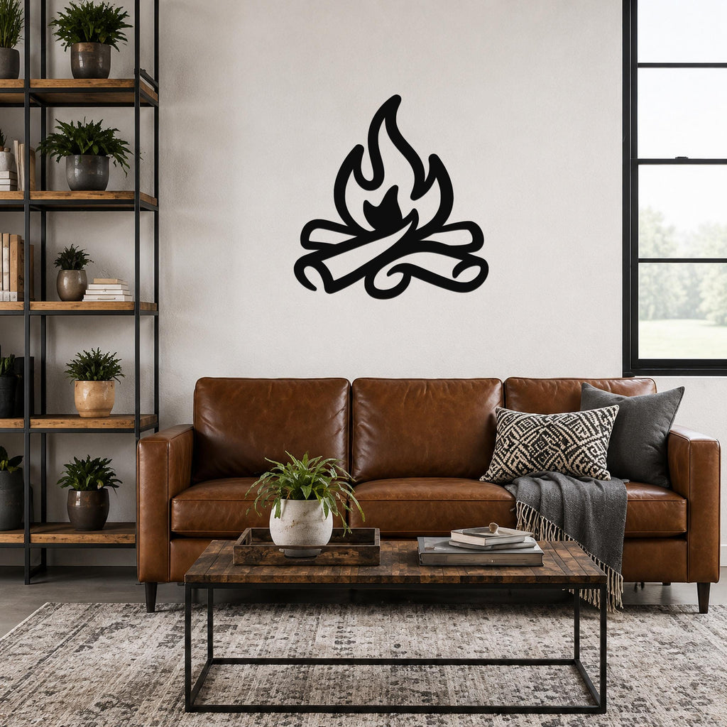 Black metal campfire wall art with flame and log silhouette, mounted above a brown leather sofa in a living room.