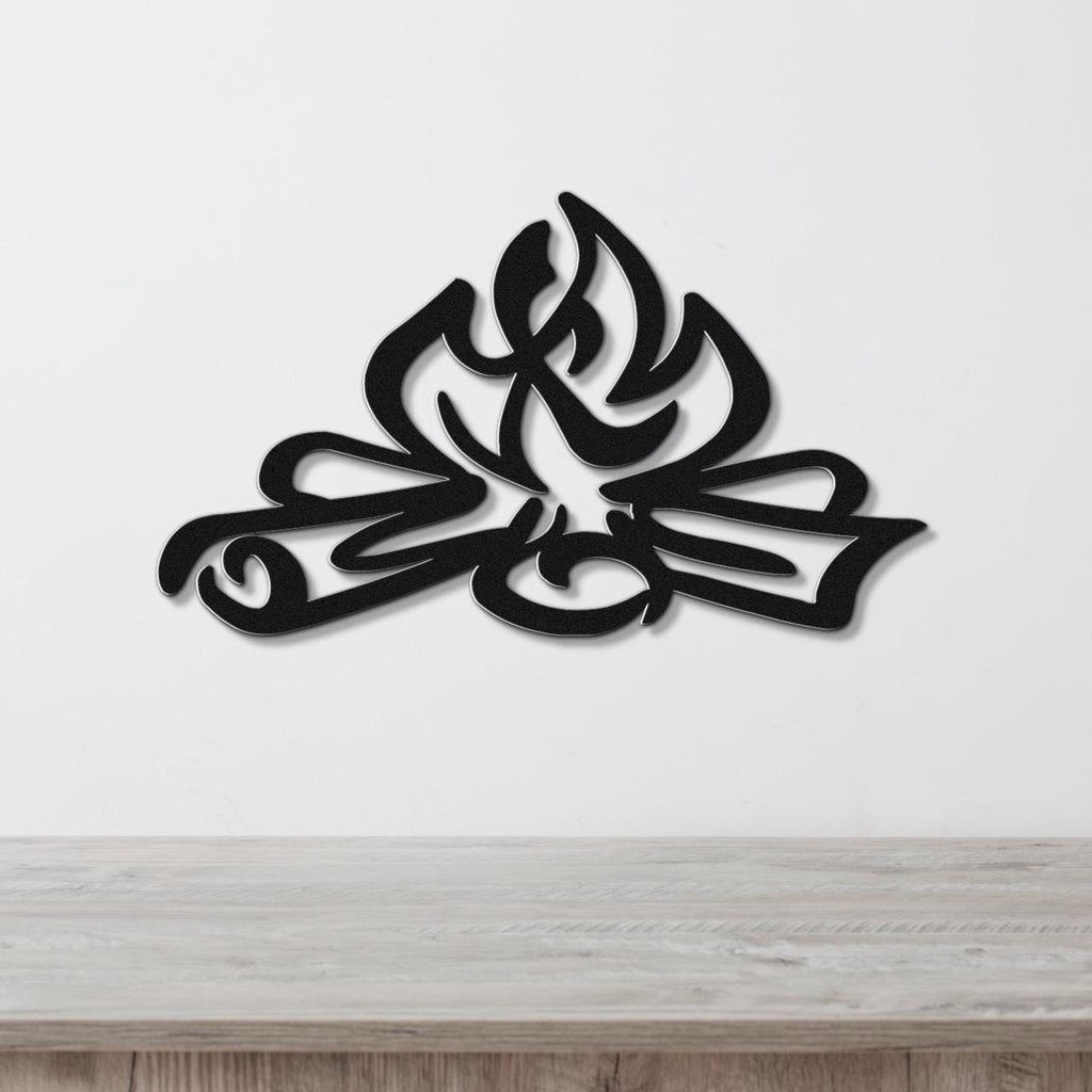 Black metal wall art with a flame and leaf cutout design, mounted on a white wall above a light wood counter.