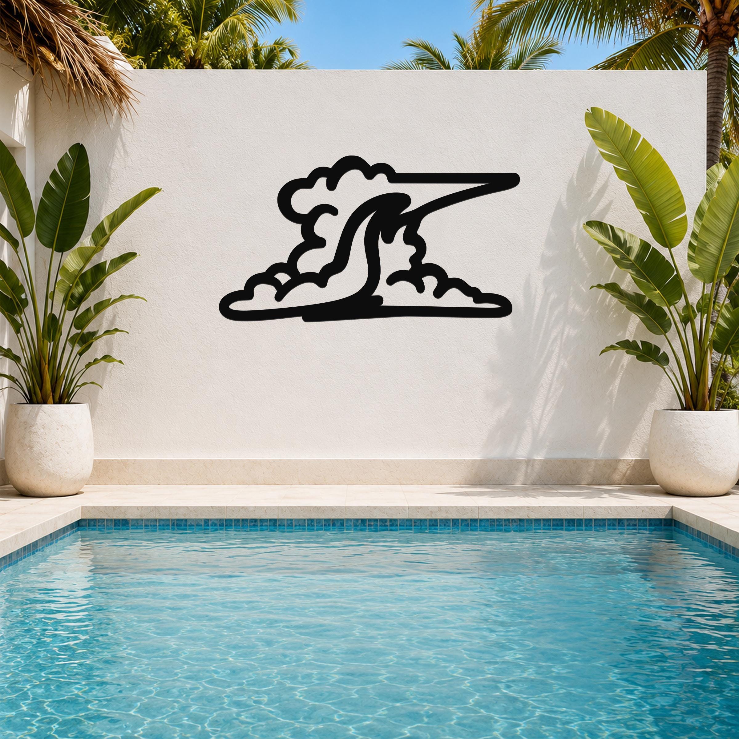Black metal wall art in a cloud silhouette design, mounted on a white outdoor wall above a pool, flanked by potted plants.