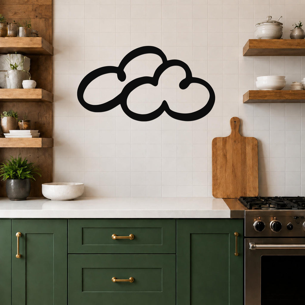 Black metal cloud wall art with a bold silhouette design, mounted on a tiled kitchen wall above a white countertop.