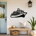 Black metal cruise ship wall art silhouette mounted on a white shiplap wall above a wooden bench in a coastal entryway.