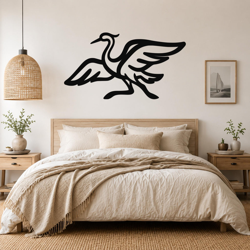 Black metal crane wall art with flowing wing and body cutouts, mounted above a wooden bed in a neutral bedroom.
