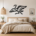 Black metal crane wall art with flowing wing and body cutouts, mounted above a wooden bed in a neutral bedroom.
