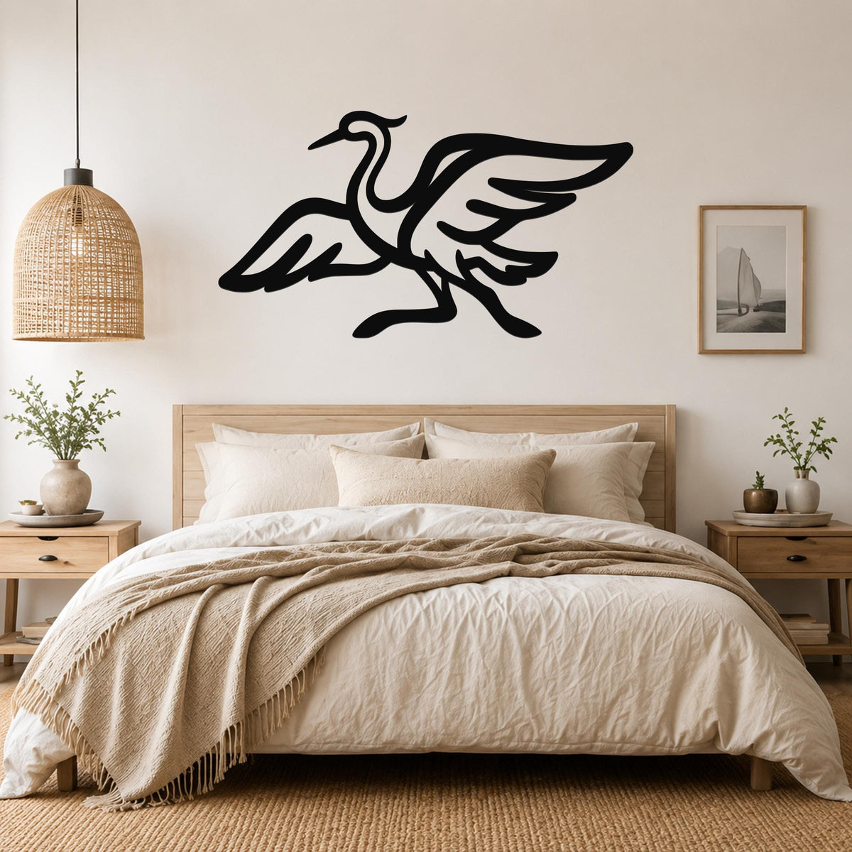 Black metal crane wall art with flowing wing and body cutouts, mounted above a wooden bed in a neutral bedroom.