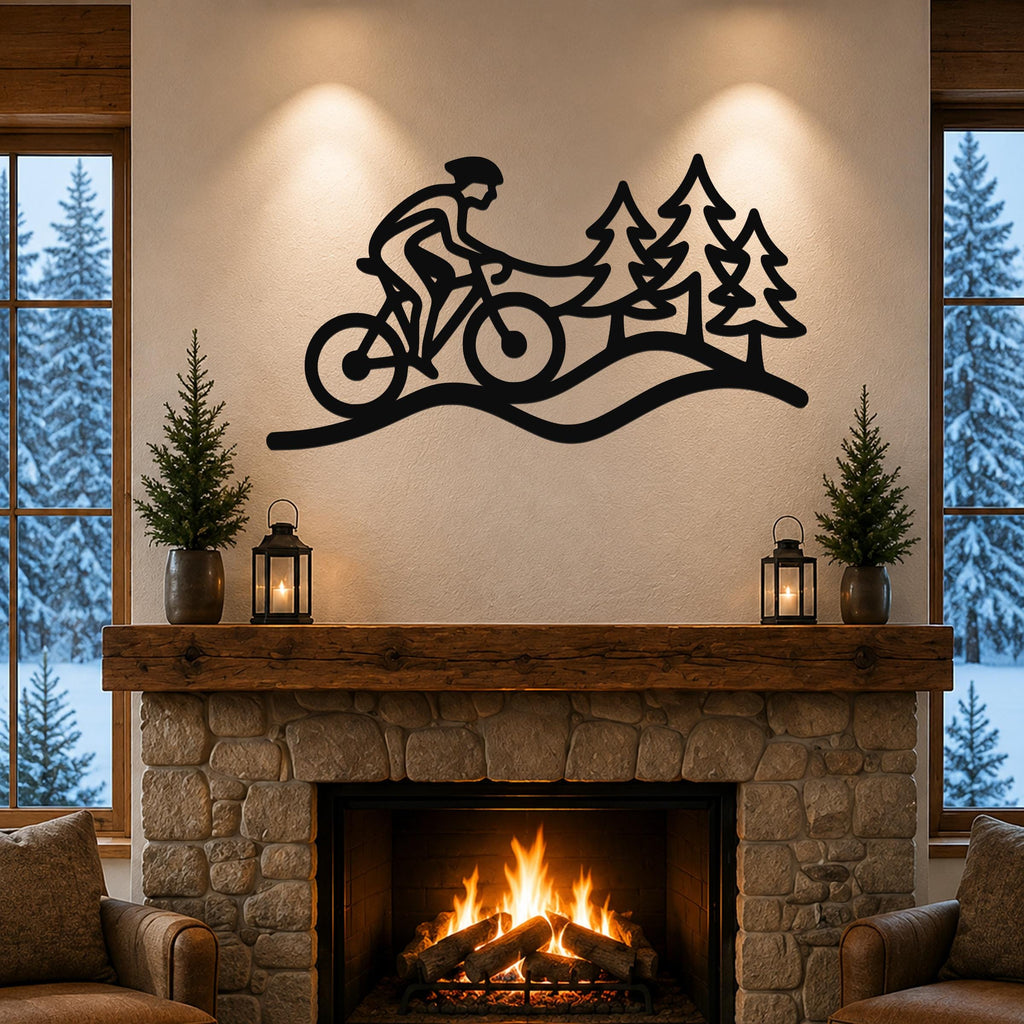 Black metal wall art silhouette of a cyclist on a trail with pine trees, mounted above a stone fireplace in a living room.