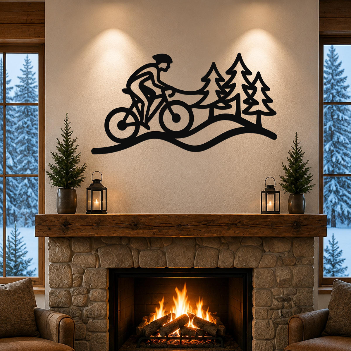 Black metal wall art silhouette of a cyclist on a trail with pine trees, mounted above a stone fireplace in a living room.
