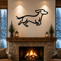 Black metal dachshund wall art with a running silhouette, mounted above a stone fireplace in a cozy living room.