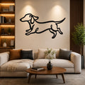 Black metal dachshund wall art with bold line cutout design, mounted above a beige sofa in a living room.