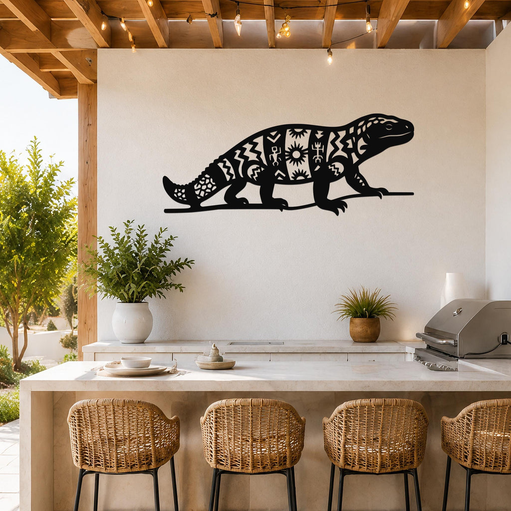 Black metal wall art of a Gila monster silhouette with intricate geometric and sun cutouts, mounted on a white wall above a kitchen counter.