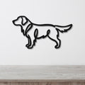Black metal wall art in the silhouette of a standing dog, mounted on a white wall above a light wood surface.