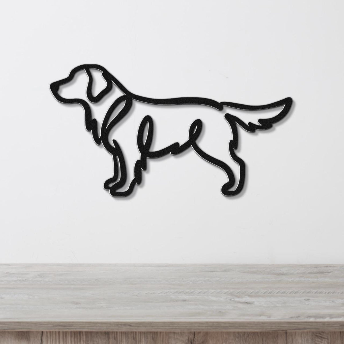 Black metal wall art in the silhouette of a standing dog, mounted on a white wall above a light wood surface.