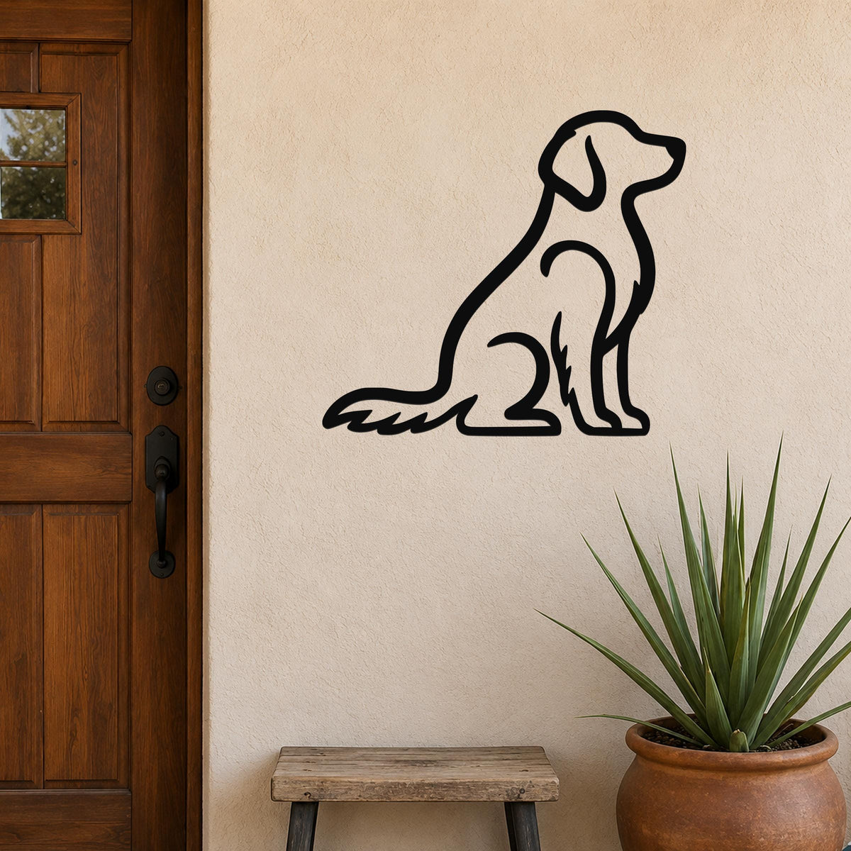 Black metal wall art in the silhouette of a sitting dog, mounted on a beige exterior wall beside a wooden door and a potted plant.