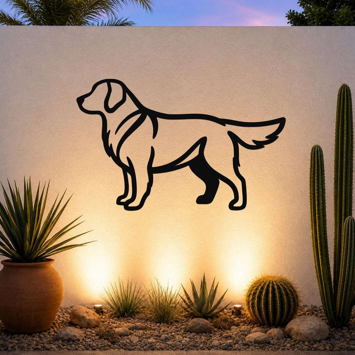Black metal Golden Retriever wall art silhouette mounted on an outdoor wall above a desert garden with cacti and warm ground lighting.
