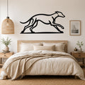 Black metal greyhound wall art with motion-line cutouts, mounted above a bed in a neutral bedroom.
