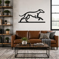 Black metal greyhound wall art with a running silhouette, mounted above a brown leather sofa in a living room.