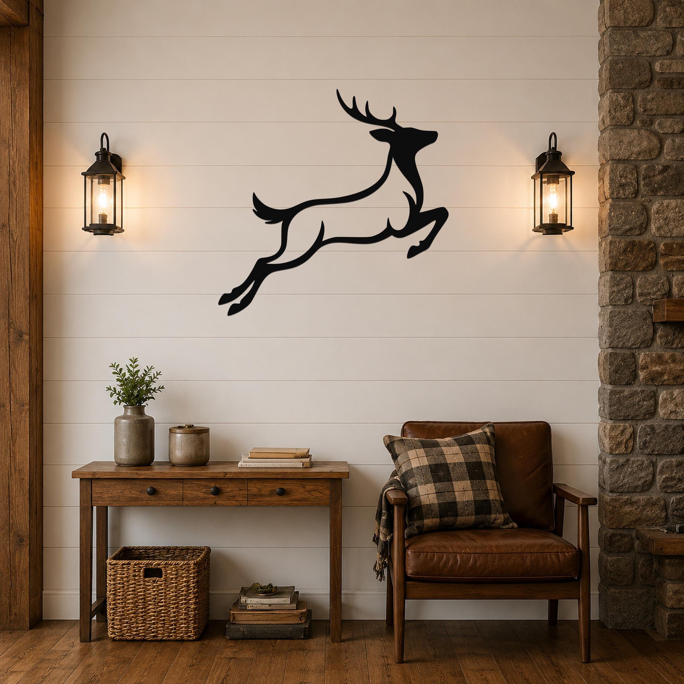 Black metal jumping deer wall art silhouette mounted on a white shiplap wall above a wooden console table in a rustic living room.