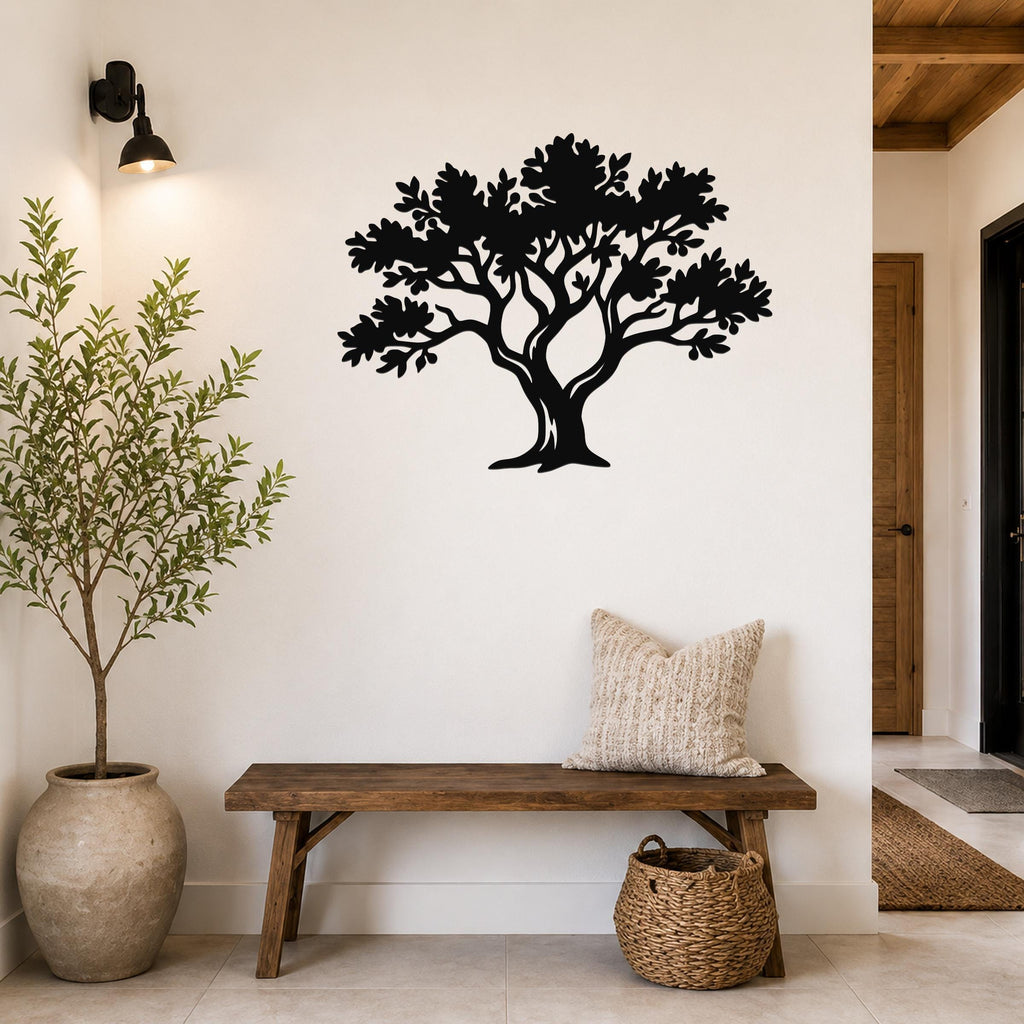 Black metal tree wall art with detailed branch and leaf cutouts, mounted on a white wall above a wooden bench in a hallway.