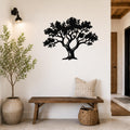 Black metal tree wall art with detailed branch and leaf cutouts, mounted on a white wall above a wooden bench in a hallway.