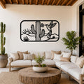Black metal wall art with a desert scene of saguaro cactus, hummingbird, and sun cutouts, mounted above a white sofa in a living room.