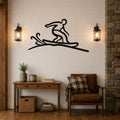 Black metal wall art silhouette of a snowboarder in motion, mounted on a shiplap wall above a wooden console table in a living room.