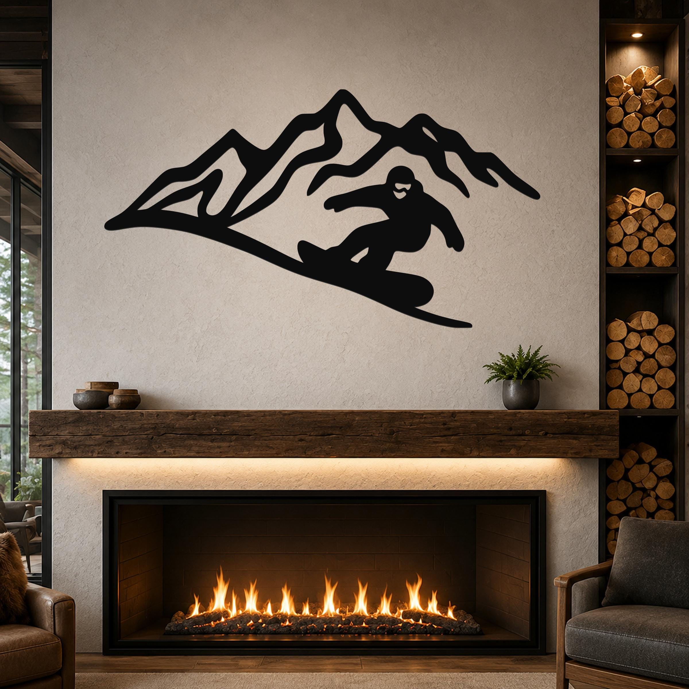 Black metal wall art featuring a snowboarder silhouette and mountain peaks, mounted above a fireplace in a living room.