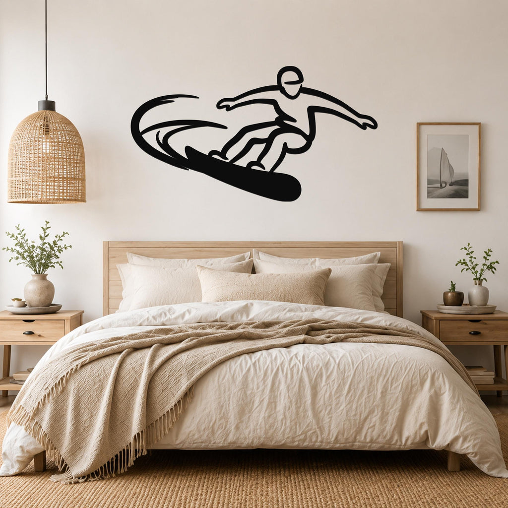 Black metal wall art silhouette of a snowboarder in motion, mounted above a bed in a neutral bedroom.