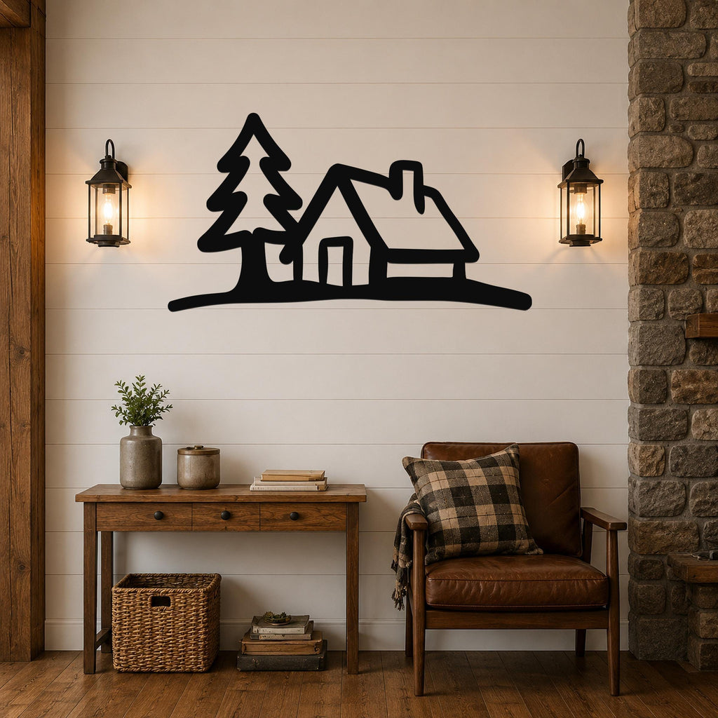 Black metal wall art silhouette of a cabin and pine tree, mounted on a shiplap wall above a wooden console table in a living room.