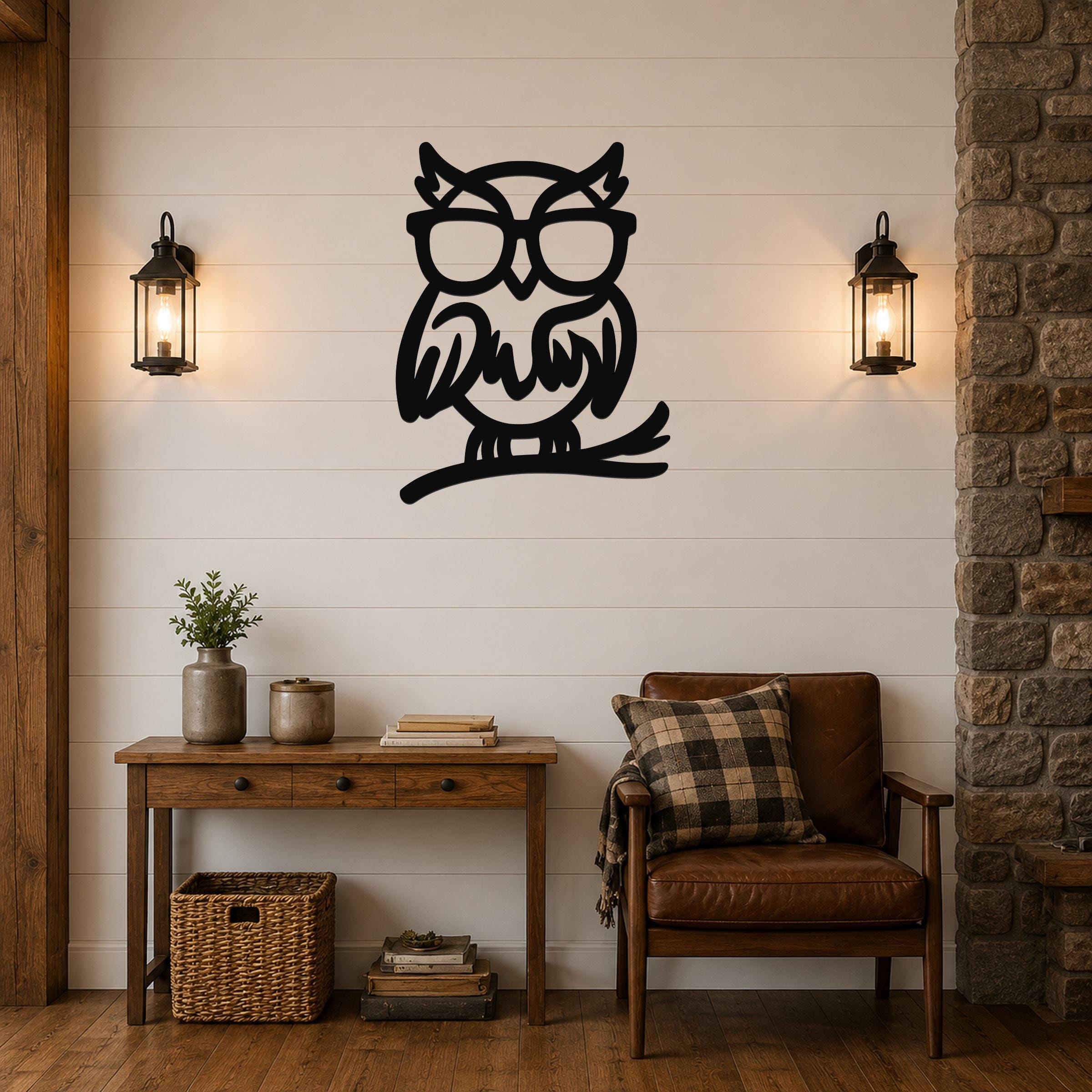 Black metal owl wall art with glasses and a branch silhouette, mounted on a shiplap wall above a wooden console table in a rustic living room.