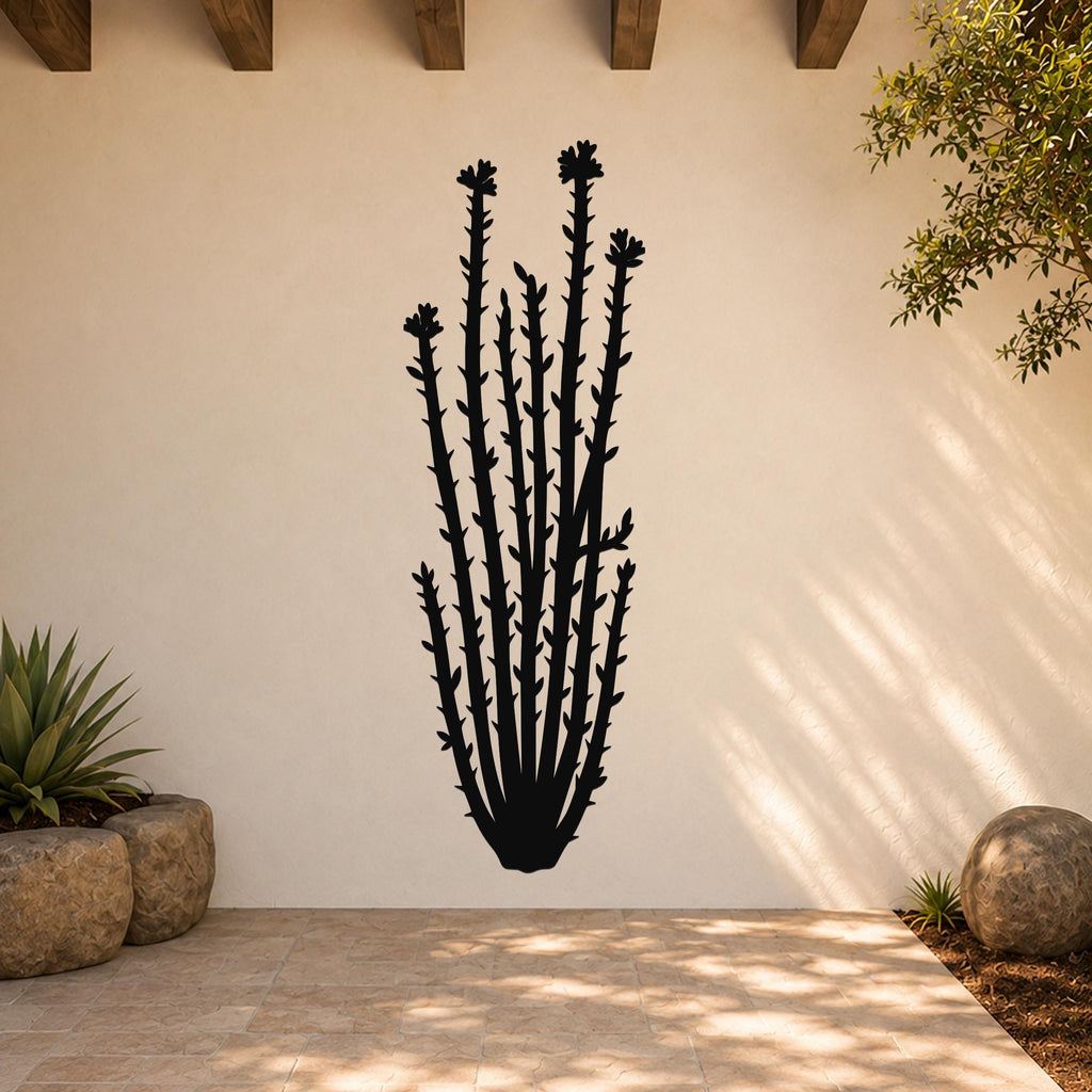 Black metal ocotillo wall art with spiny stems and flower cutouts, mounted on a light-colored outdoor wall above a tiled patio.