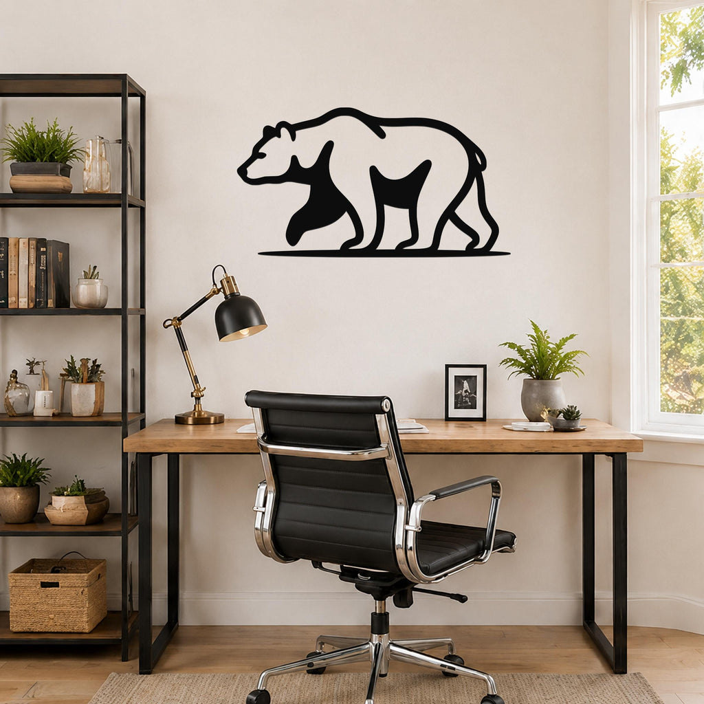 Black metal bear silhouette wall art mounted above a wooden desk in a modern home office.