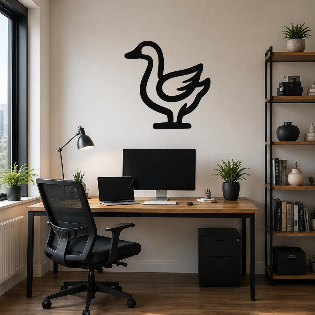 Black metal goose wall art silhouette mounted on a beige wall above a wooden desk in a modern home office.