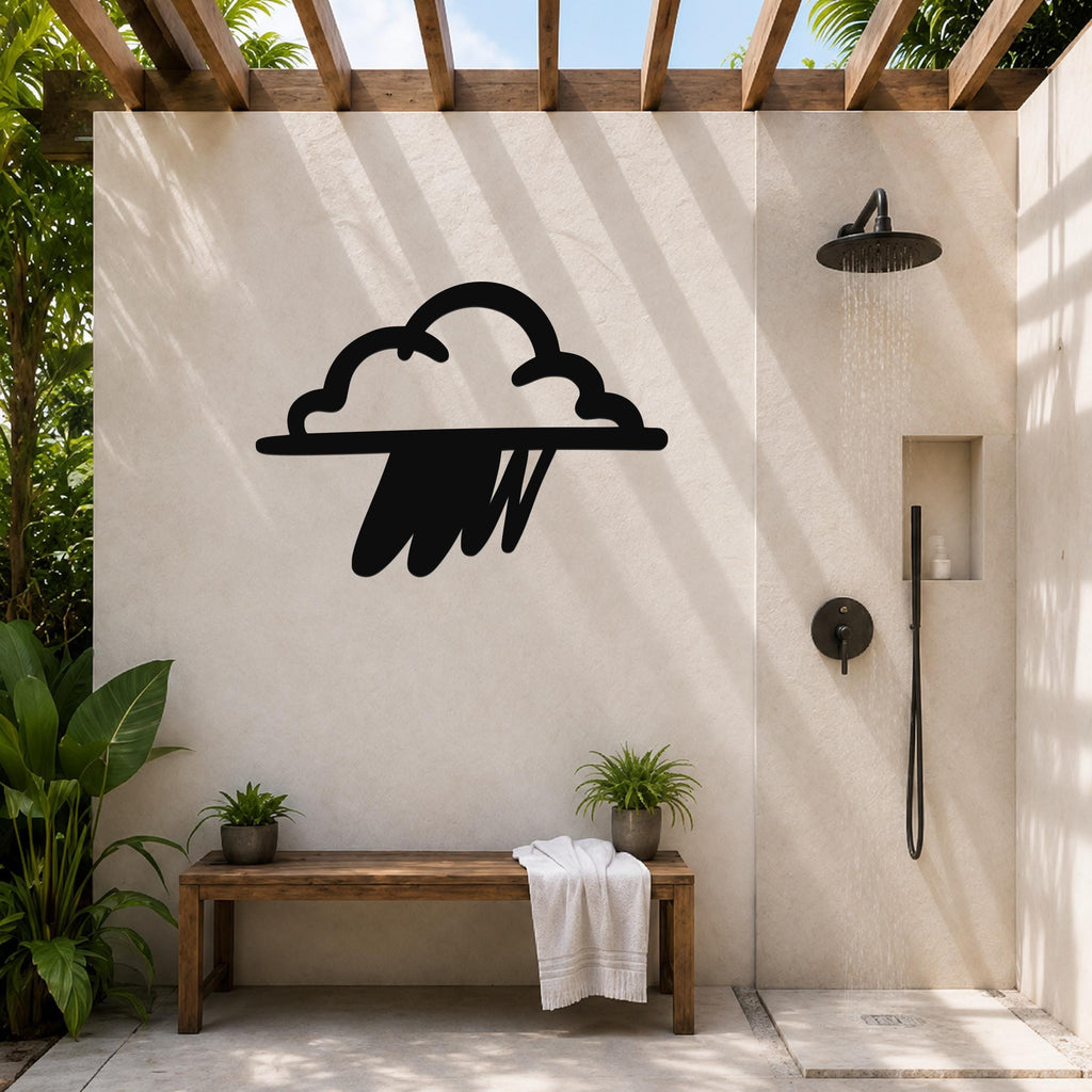 Black metal rain cloud wall art with raindrop cutouts, mounted on a beige outdoor shower wall above a wooden bench.