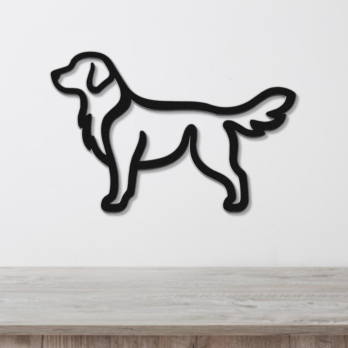 Black metal retriever silhouette wall art with a clean outline, mounted on a white wall above a light wood surface.